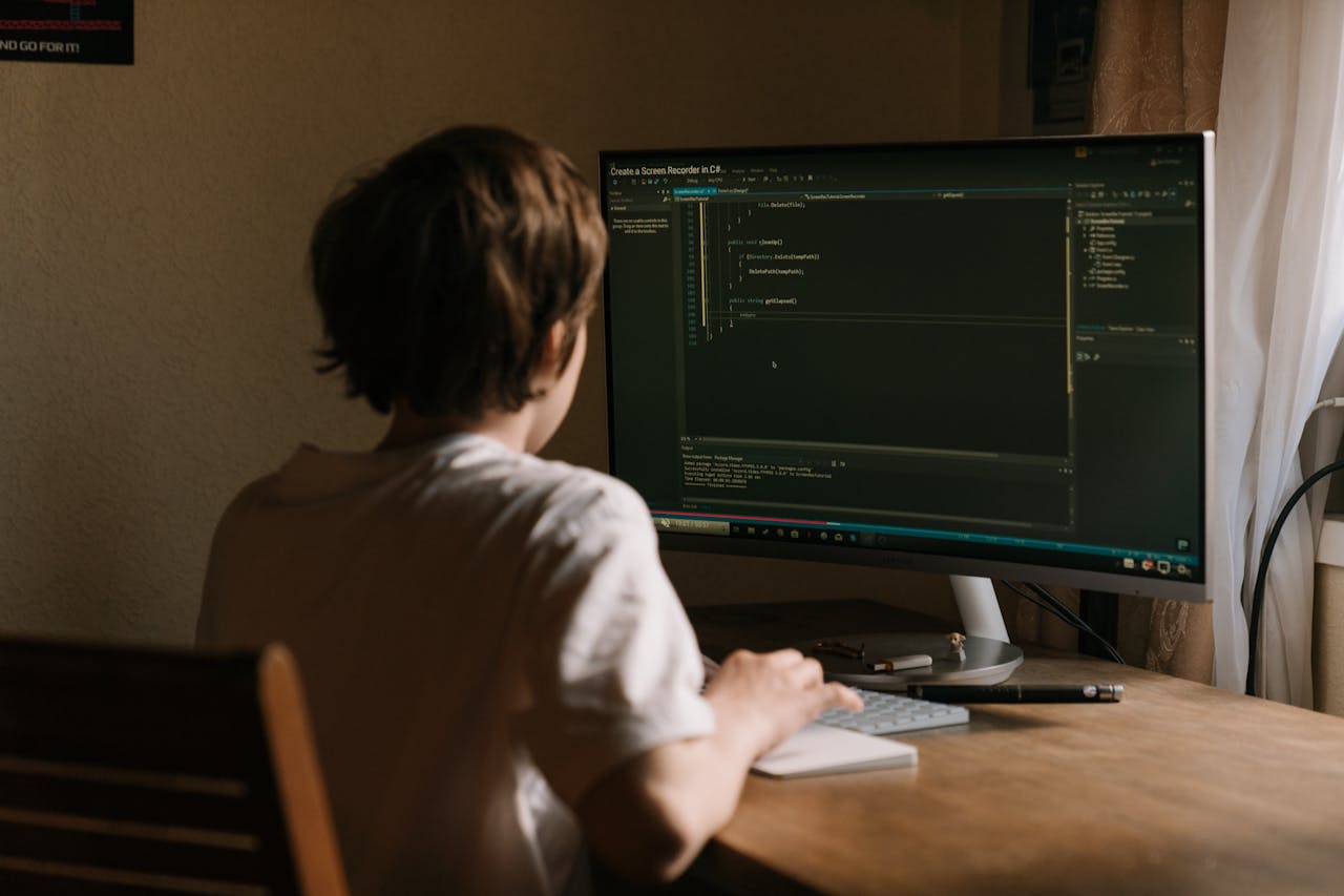 Person in White Shirt Using Computer