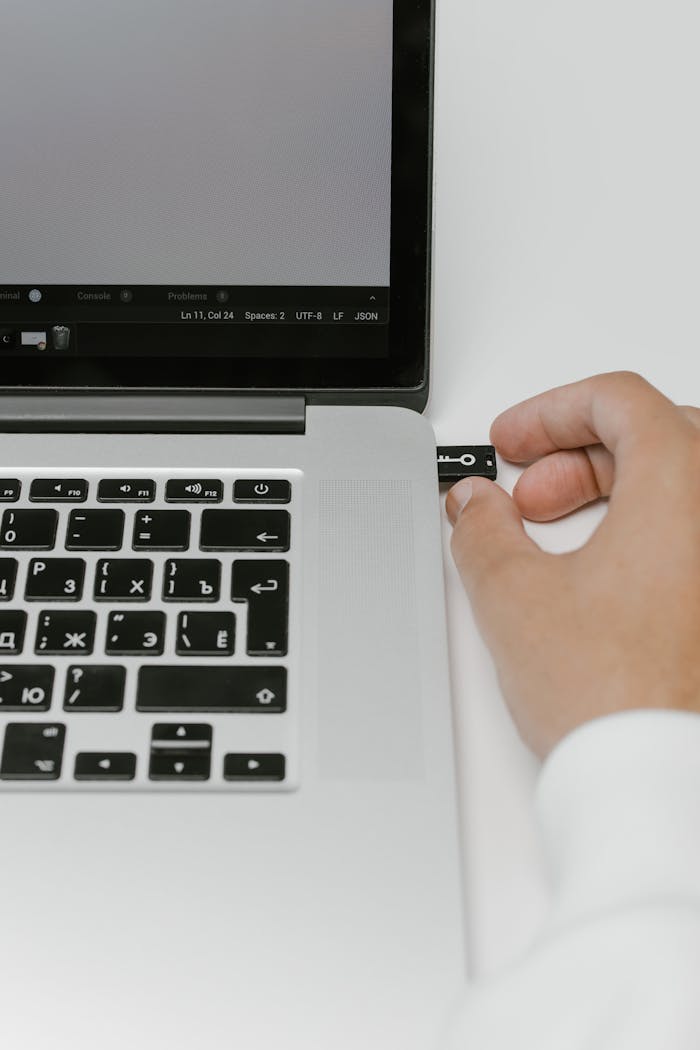 Hand Putting a USB Flash Drive in a Laptop